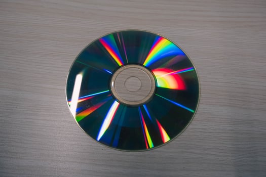 Stack of compact disks on a wooden table. Vcd, blueray photo