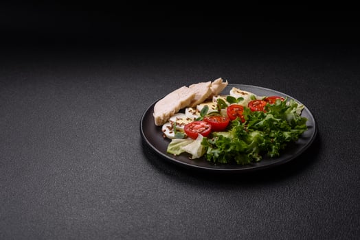 Delicious fresh caesar salad in a bowl with chicken breast, egg, tomatoes photo