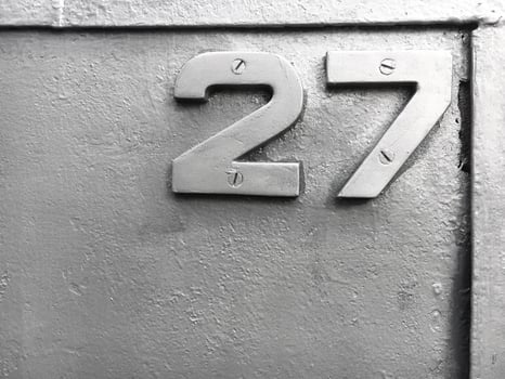 Silver number 27 on a silvery metallic background photo