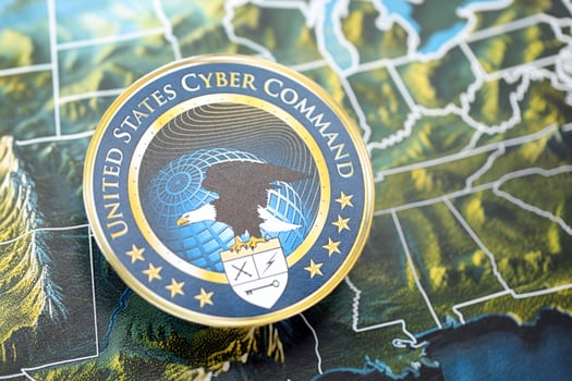 KYIV, UKRAINE - JUNE 26, 2024 United States Cyber Command coat of arms on paper map of United States photo