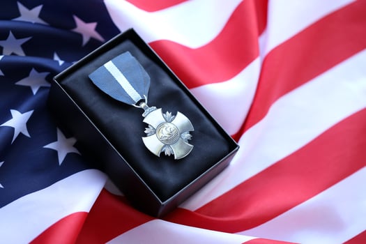 KYIV, UKRAINE - JULY 10, 2024 US Navy Cross medal. United States military award medal with ribbon and pin. Handmade paper theater props photo