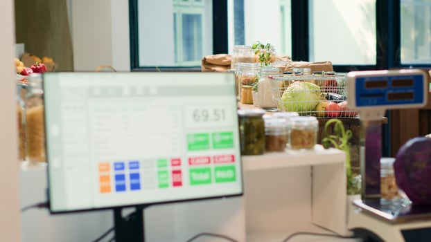 Low carbon footprint food in local supermarket, checkout counter with cash register used to purchase natural herbs or organic produce. Fruits, vegetables, grains, spices and pasta on display. photo