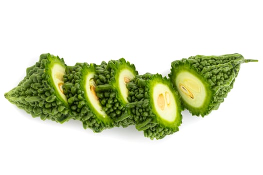 Fresh bitter gourd Bitter cucumber or bitter melon with cut slice isolated on a white background. photo