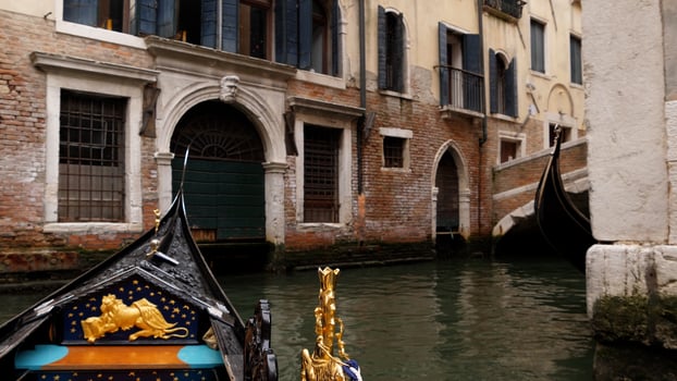 View of the Grand Canal from a gondola in Venice, Italy. The front part of the gondola on the background of the views of Venice photo