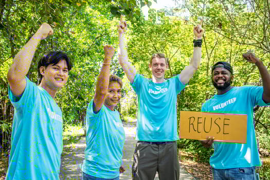 volunteering, charity, people, gesture and ecology concept - group of happy volunteers showing thumbs up and greeting you in park photo