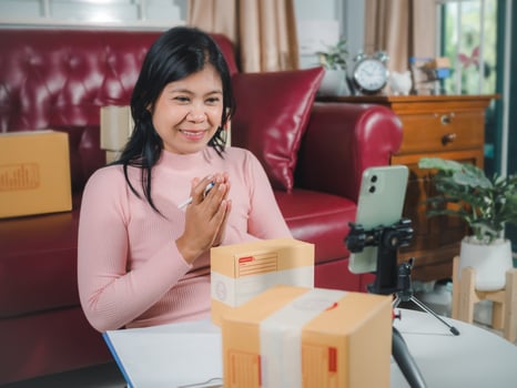 Live to sell products, woman blogger review products from camera on her phone, Business online influencer on social media concept, Ecommerce business live streaming vlog new normal concept. photo