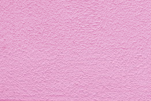 Pink plaster wall of a building. Rough surface texture. photo