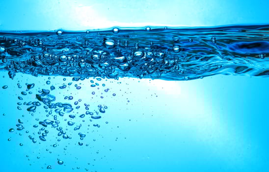Fresh Water With Underwater Bubbles Texture on a Blue Background Close-up Abstract Liquid Bubbles Aqua Design Wallpaper photo