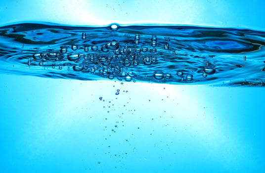 Fresh Water With Underwater Bubbles Texture on a Blue Background Close-up Abstract Liquid Bubbles Aqua Design Wallpaper photo