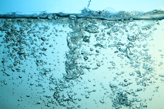 Fresh Water With Underwater Bubbles Texture on a Blue Background Close-up Abstract Liquid Bubbles Aqua Design Wallpaper photo