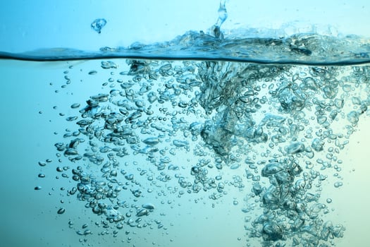Fresh Water With Underwater Bubbles Texture on a Blue Background Close-up Abstract Liquid Bubbles Aqua Design Wallpaper photo