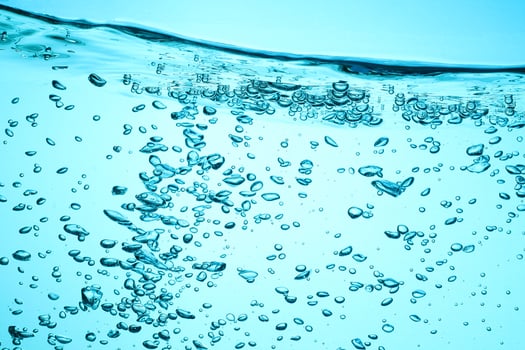 Fresh Water With Underwater Bubbles Texture on a Blue Background Close-up Abstract Liquid Bubbles Aqua Design Wallpaper photo