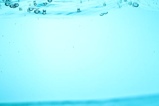 Fresh Water With Underwater Bubbles Texture on a Blue Background Close-up Abstract Liquid Bubbles Aqua Design Wallpaper photo
