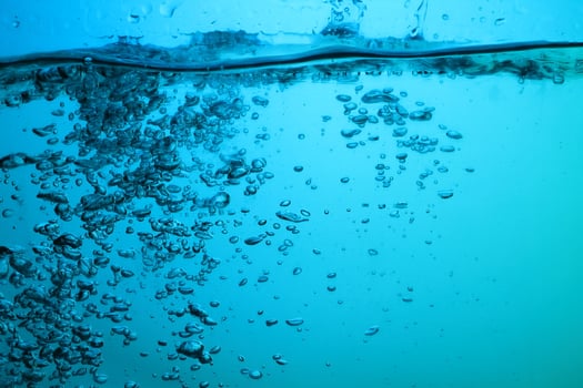 Fresh Water With Underwater Bubbles Texture on a Blue Background Close-up Abstract Liquid Bubbles Aqua Design Wallpaper photo
