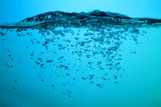 Fresh Water With Underwater Bubbles Texture on a Blue Background Close-up Abstract Liquid Bubbles Aqua Design Wallpaper photo