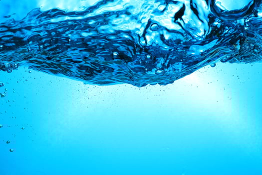 Fresh Water With Underwater Bubbles Texture on a Blue Background Close-up Abstract Liquid Bubbles Aqua Design Wallpaper photo