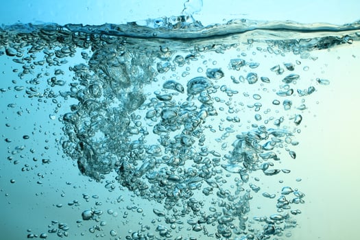 Fresh Water With Underwater Bubbles Texture on a Blue Background Close-up Abstract Liquid Bubbles Aqua Design Wallpaper photo