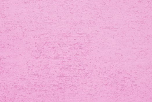 Pink plaster wall of a building. Rough surface texture. photo