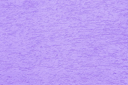 Violet plaster wall of a building. Rough surface texture. photo