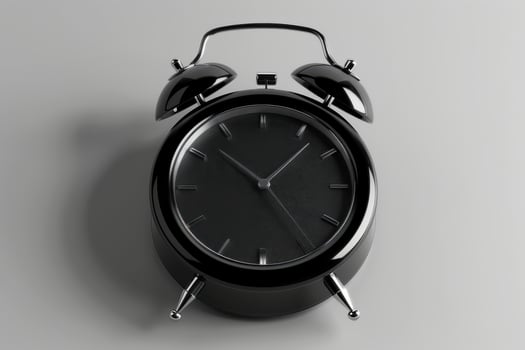 Black vintage alarm clock resting on a minimalist surface, showcasing elegant timekeeping details in soft morning light photo
