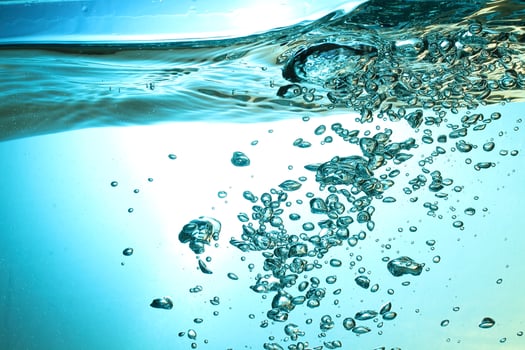 Fresh Water With Underwater Bubbles Texture on a Blue Background Close-up Abstract Liquid Bubbles Aqua Design Wallpaper photo