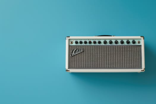 Vintage-style amplifier on a vibrant turquoise background creating a retro music vibe photo