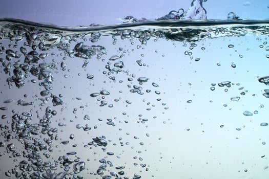 Fresh Water With Underwater Bubbles Texture on a Blue Background Close-up Abstract Liquid Bubbles Aqua Design Wallpaper photo