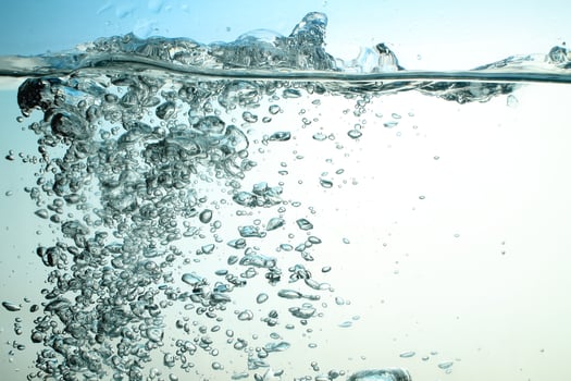 Fresh Water With Underwater Bubbles Texture on a Blue Background Close-up Abstract Liquid Bubbles Aqua Design Wallpaper photo