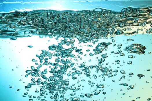 Fresh Water With Underwater Bubbles Texture on a Blue Background Close-up Abstract Liquid Bubbles Aqua Design Wallpaper photo