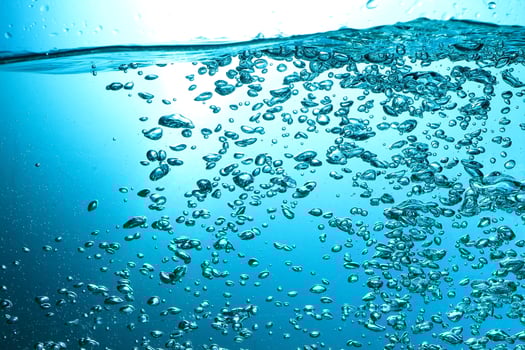 Fresh Water With Underwater Bubbles Texture on a Blue Background Close-up Abstract Liquid Bubbles Aqua Design Wallpaper photo