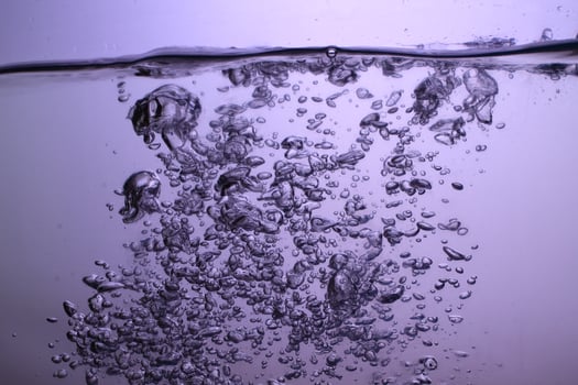 Fresh Water With Underwater Bubbles Texture on a Blue Background Close-up Abstract Liquid Bubbles Aqua Design Wallpaper photo