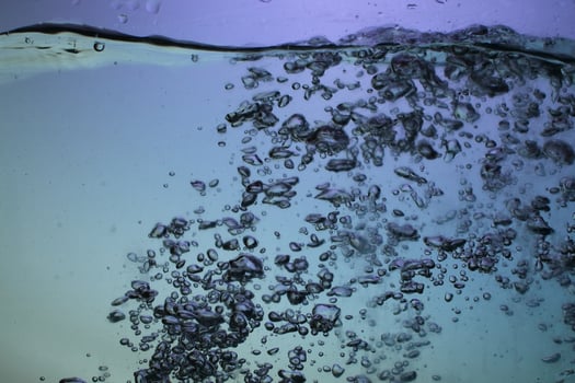 Fresh Water With Underwater Bubbles Texture on a Blue Background Close-up Abstract Liquid Bubbles Aqua Design Wallpaper photo