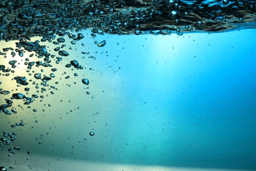 Fresh Water With Underwater Bubbles Texture on a Blue Background Close-up Abstract Liquid Bubbles Aqua Design Wallpaper photo
