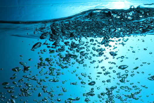 Fresh Water With Underwater Bubbles Texture on a Blue Background Close-up Abstract Liquid Bubbles Aqua Design Wallpaper photo