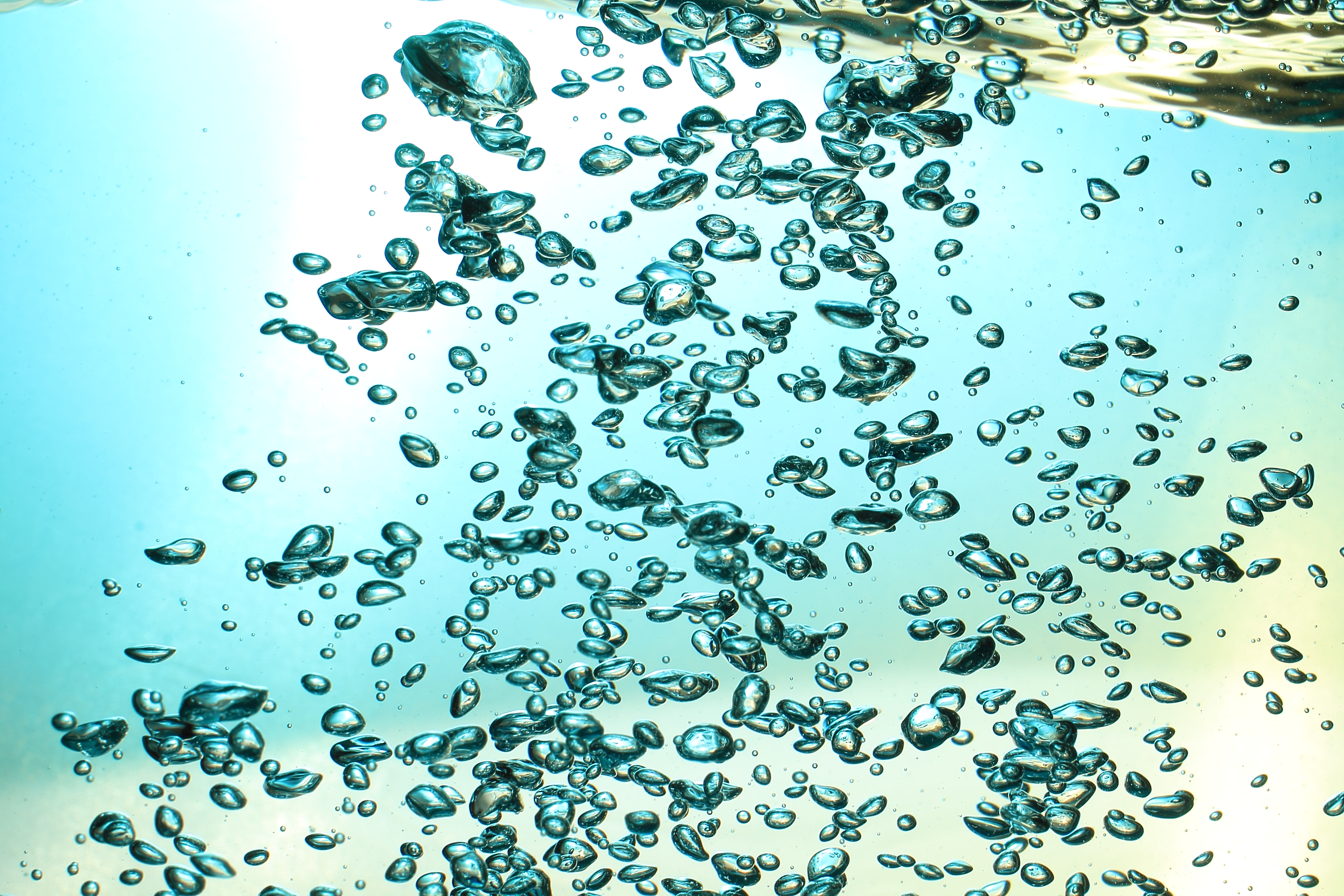 Fresh Water With Underwater Bubbles Texture on a Blue Background Close-up Abstract Liquid Bubbles Aqua Design Wallpaper photo