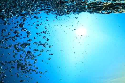 Fresh Water With Underwater Bubbles Texture on a Blue Background Close-up Abstract Liquid Bubbles Aqua Design Wallpaper photo
