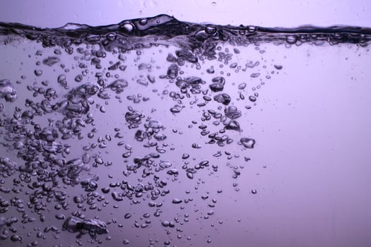 Fresh Water With Underwater Bubbles Texture on a Blue Background Close-up Abstract Liquid Bubbles Aqua Design Wallpaper photo