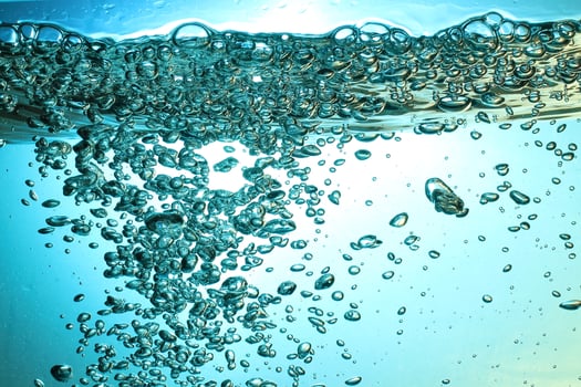 Fresh Water With Underwater Bubbles Texture on a Blue Background Close-up Abstract Liquid Bubbles Aqua Design Wallpaper photo