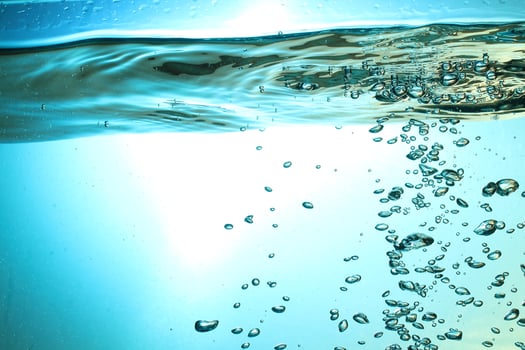 Fresh Water With Underwater Bubbles Texture on a Blue Background Close-up Abstract Liquid Bubbles Aqua Design Wallpaper photo