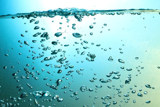 Fresh Water With Underwater Bubbles Texture on a Blue Background Close-up Abstract Liquid Bubbles Aqua Design Wallpaper photo