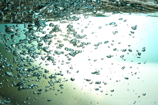 Fresh Water With Underwater Bubbles Texture on a Blue Background Close-up Abstract Liquid Bubbles Aqua Design Wallpaper photo