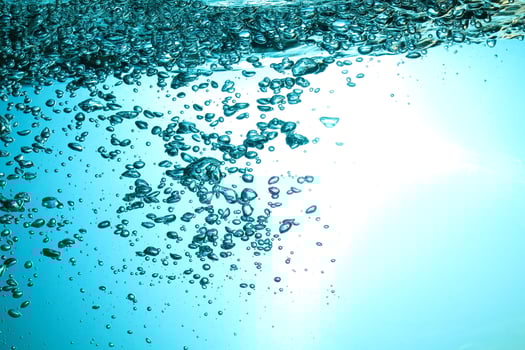 Fresh Water With Underwater Bubbles Texture on a Blue Background Close-up Abstract Liquid Bubbles Aqua Design Wallpaper photo