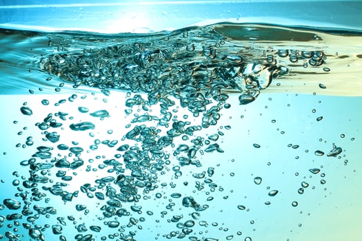 Fresh Water With Underwater Bubbles Texture on a Blue Background Close-up Abstract Liquid Bubbles Aqua Design Wallpaper photo