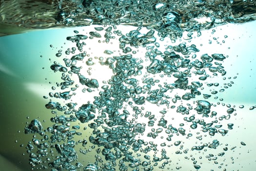 Fresh Water With Underwater Bubbles Texture on a Blue Background Close-up Abstract Liquid Bubbles Aqua Design Wallpaper photo