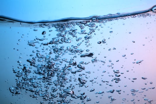 Fresh Water With Underwater Bubbles Texture on a Blue Background Close-up Abstract Liquid Bubbles Aqua Design Wallpaper photo