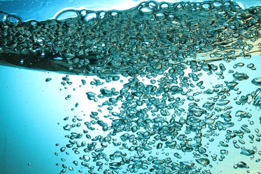 Fresh Water With Underwater Bubbles Texture on a Blue Background Close-up Abstract Liquid Bubbles Aqua Design Wallpaper photo