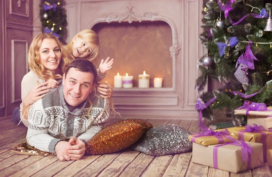 Stylish family celebrating christmas in room near the christmas tree photo