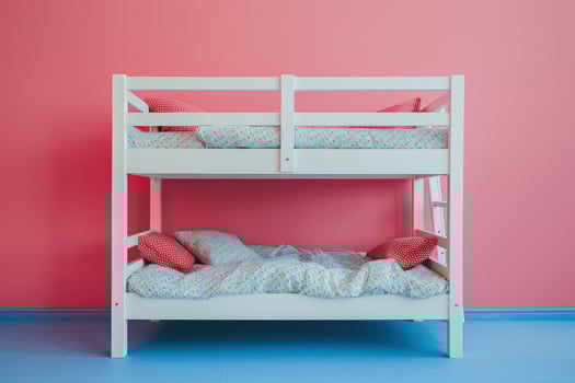 Cozy bunk beds nestled against a vibrant pink wall in a playful child's room during daylight photo