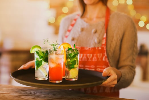 Young pretty woman with red and green cocktails on tray photo