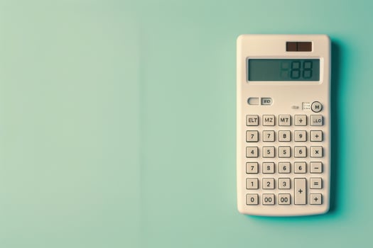 A vintage calculator displaying numbers on a pastel green wall in a cozy workspace setting photo